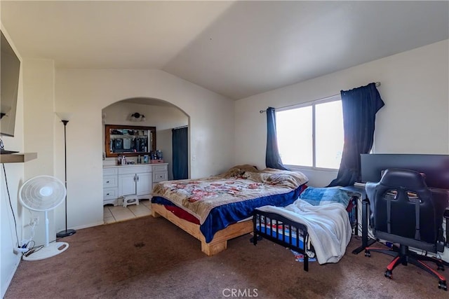 bedroom featuring vaulted ceiling and light carpet