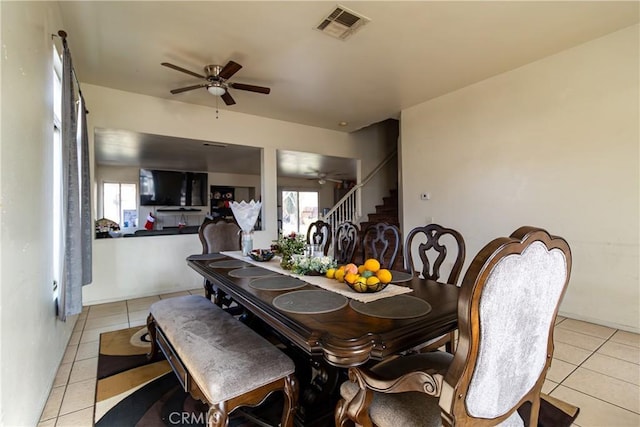 dining room featuring light tile patterned floors and ceiling fan