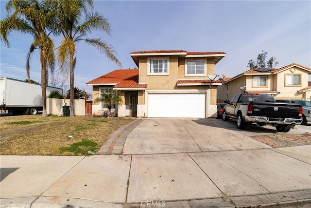 mediterranean / spanish house featuring a garage and a front lawn