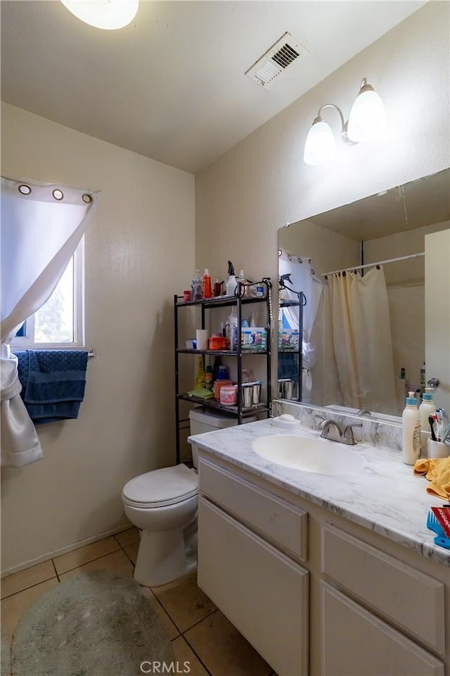 bathroom featuring vanity, curtained shower, tile patterned floors, and toilet