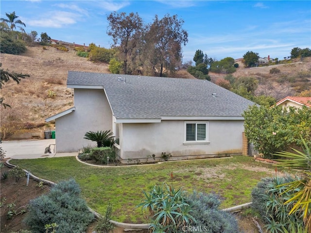 view of side of home with a yard