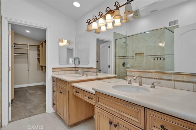 bathroom with a shower with shower door, lofted ceiling, decorative backsplash, tile patterned flooring, and vanity