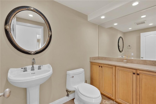 bathroom featuring toilet and sink