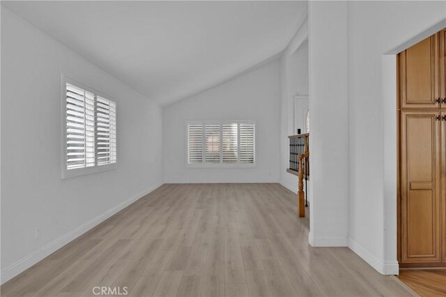 unfurnished living room with lofted ceiling and light hardwood / wood-style floors