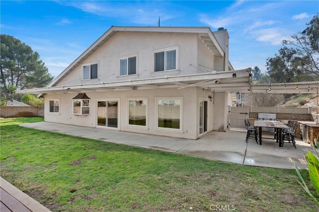 rear view of house with a yard, a pergola, and a patio