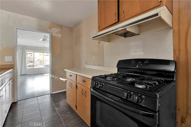 kitchen featuring ceiling fan, black range with gas cooktop, and dark tile patterned floors