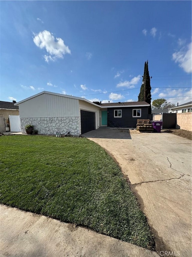 ranch-style home with a garage and a front yard