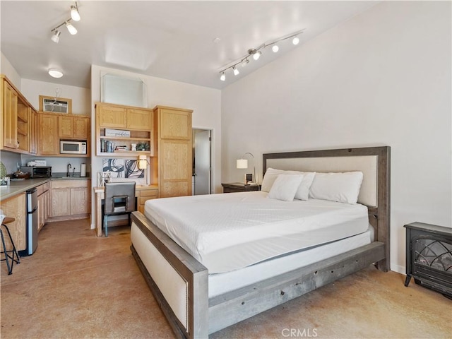 bedroom featuring concrete flooring and track lighting