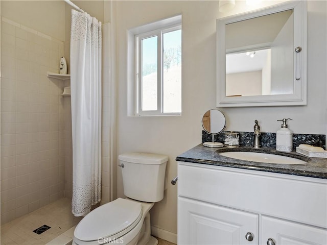 full bath featuring toilet, tiled shower, and vanity