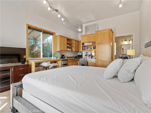 bedroom featuring rail lighting and built in desk