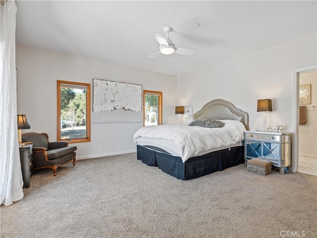 carpeted bedroom with baseboards and a ceiling fan