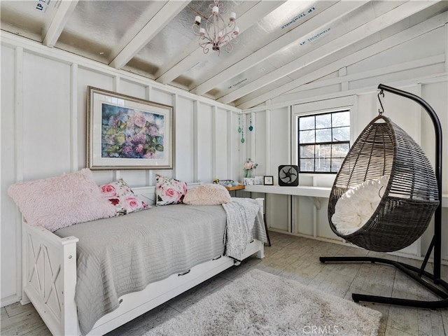 bedroom with a chandelier, light wood-type flooring, and lofted ceiling