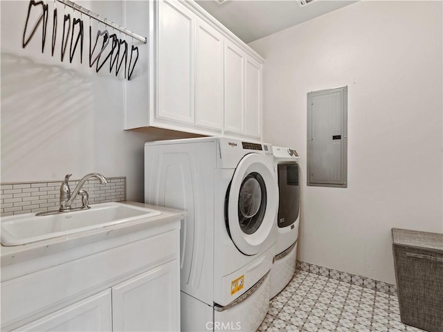 clothes washing area with light floors, cabinet space, a sink, separate washer and dryer, and electric panel