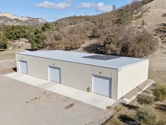 view of outbuilding with a mountain view and an outdoor structure