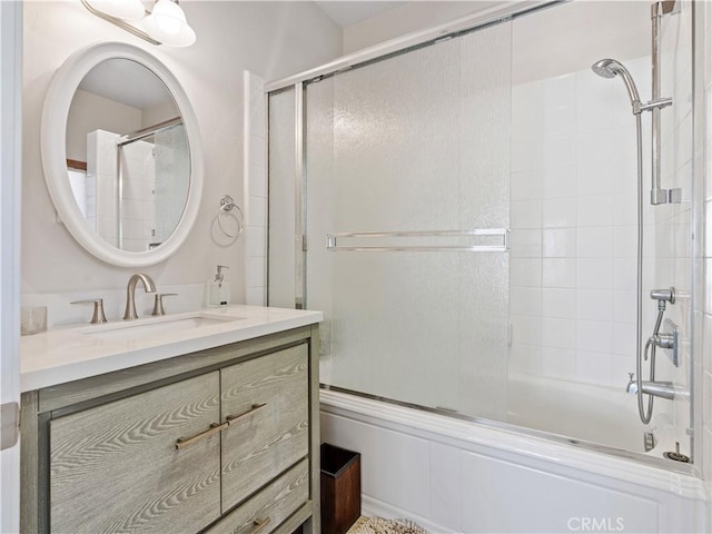 bathroom with vanity and bath / shower combo with glass door