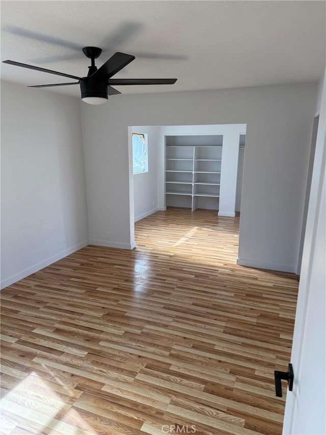 empty room featuring ceiling fan and light hardwood / wood-style flooring