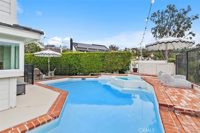 view of pool featuring a patio and an in ground hot tub