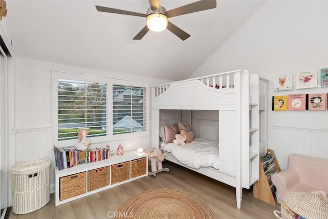 bedroom with hardwood / wood-style flooring, vaulted ceiling, and ceiling fan