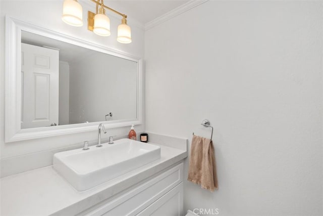 bathroom featuring ornamental molding and vanity