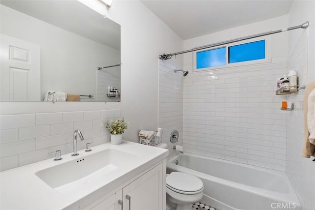 full bathroom featuring vanity, decorative backsplash, toilet, and tiled shower / bath