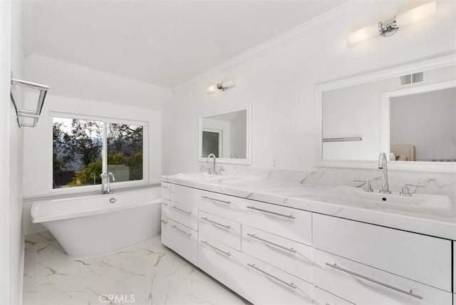 bathroom with vanity, a tub, and ornamental molding