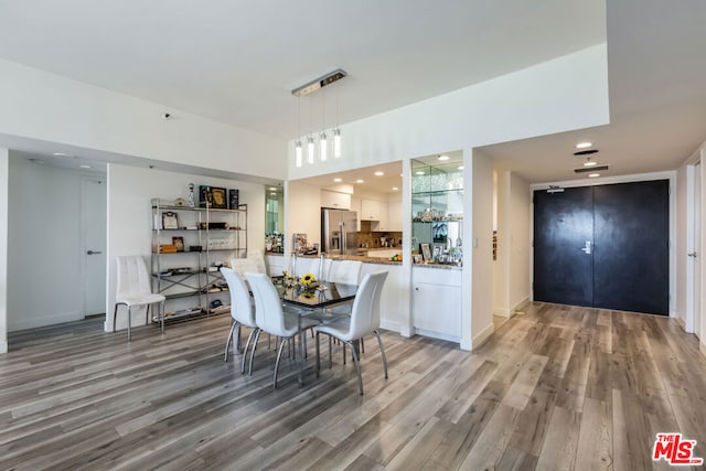 dining space featuring wood-type flooring