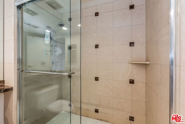 bathroom with a shower with shower door