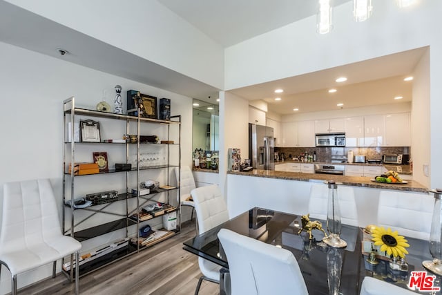 dining space with wood-type flooring