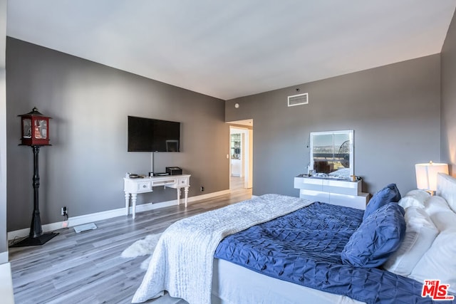 bedroom with wood-type flooring