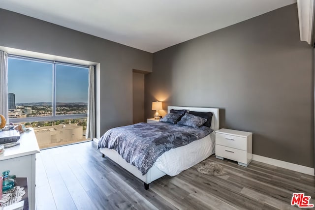 bedroom with dark wood-type flooring