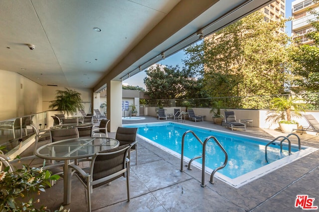 view of pool featuring a patio