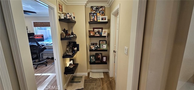 corridor with hardwood / wood-style flooring and ornamental molding