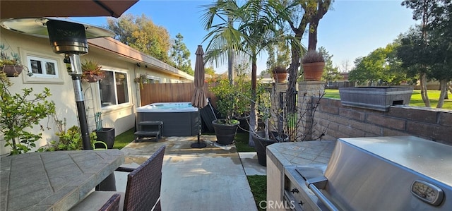 view of patio / terrace with a hot tub