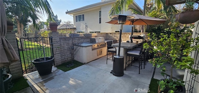 view of patio / terrace with exterior kitchen, an outdoor bar, and grilling area