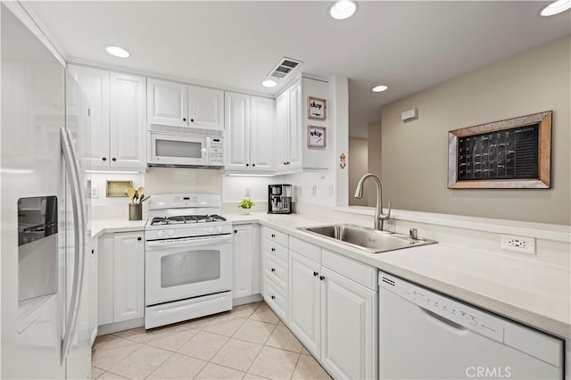 kitchen with sink, white cabinetry, light tile patterned floors, kitchen peninsula, and white appliances