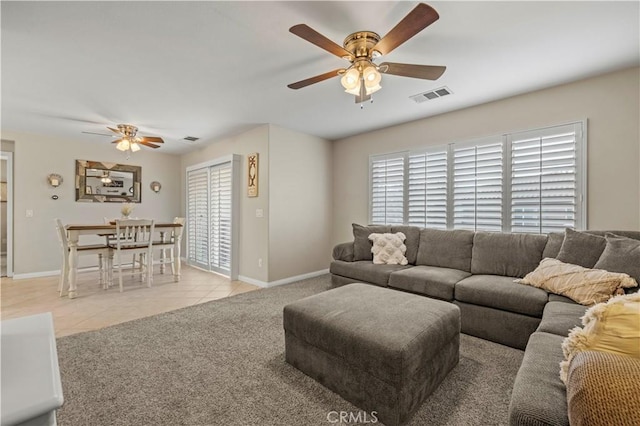 living room featuring light colored carpet and ceiling fan