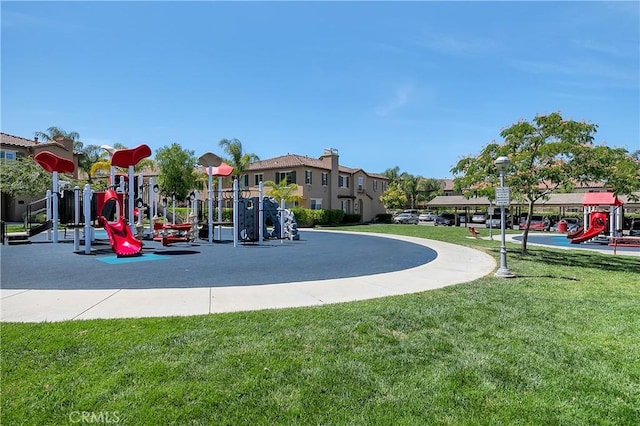 community jungle gym featuring a yard