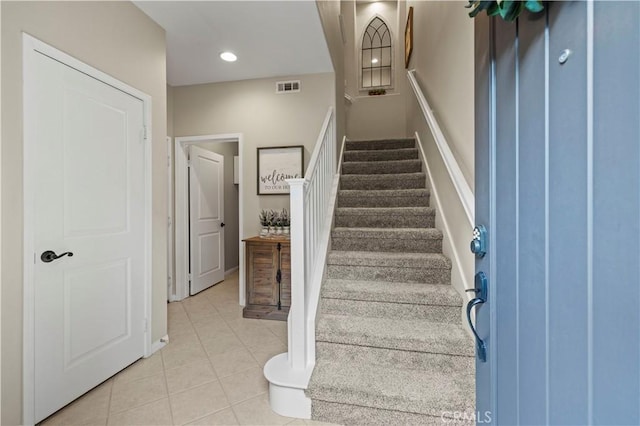 stairway with tile patterned flooring