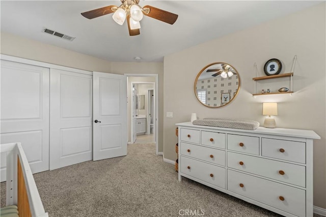 unfurnished bedroom featuring light carpet, a closet, and ceiling fan