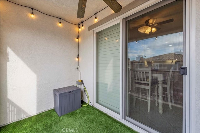 property entrance with ceiling fan