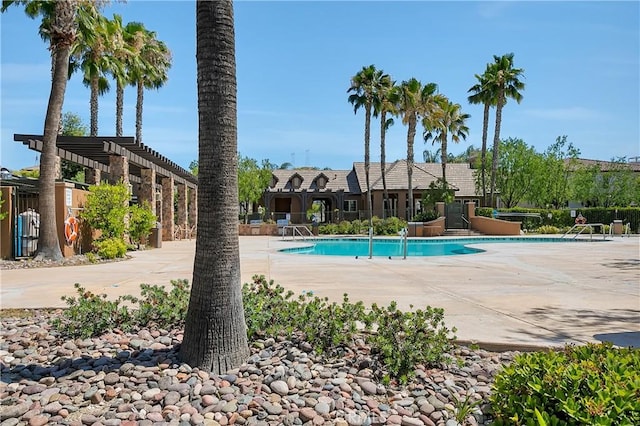 view of swimming pool with a pergola and a patio