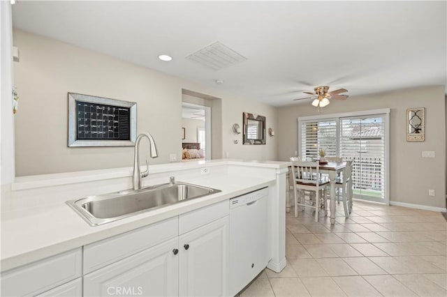 kitchen featuring sink, light tile patterned floors, ceiling fan, white cabinetry, and white dishwasher