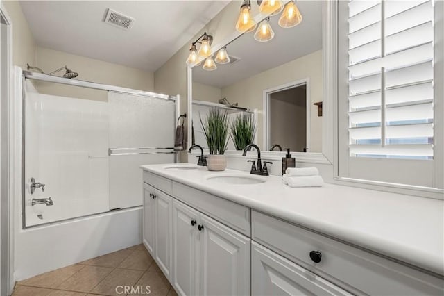 bathroom with enclosed tub / shower combo, vanity, and tile patterned flooring