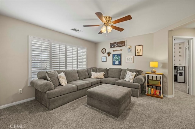 carpeted living room with a ceiling fan, visible vents, and baseboards