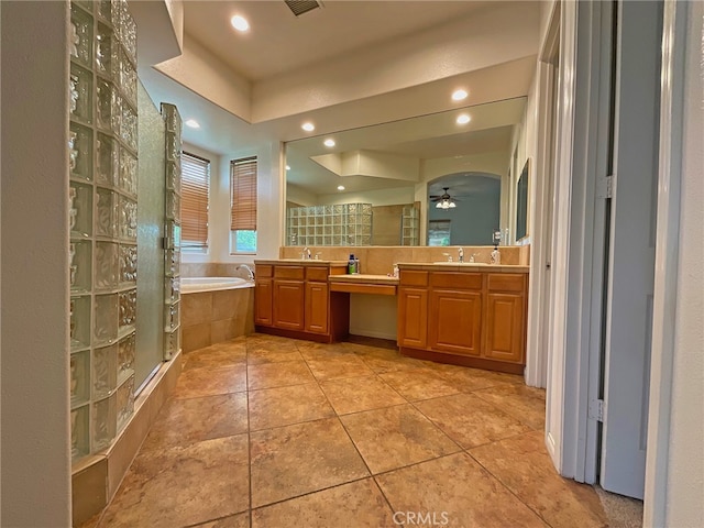 bathroom with vanity, tile patterned floors, ceiling fan, and plus walk in shower