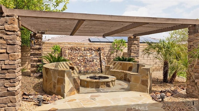 view of patio featuring a pergola and an outdoor fire pit