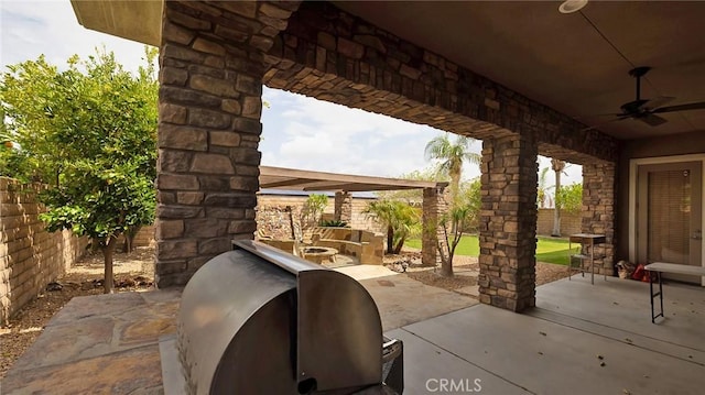 view of patio with area for grilling and ceiling fan