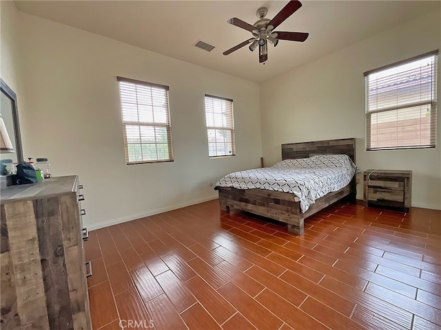 bedroom with ceiling fan and dark hardwood / wood-style flooring