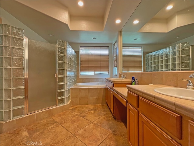 bathroom featuring vanity, independent shower and bath, and tile patterned flooring