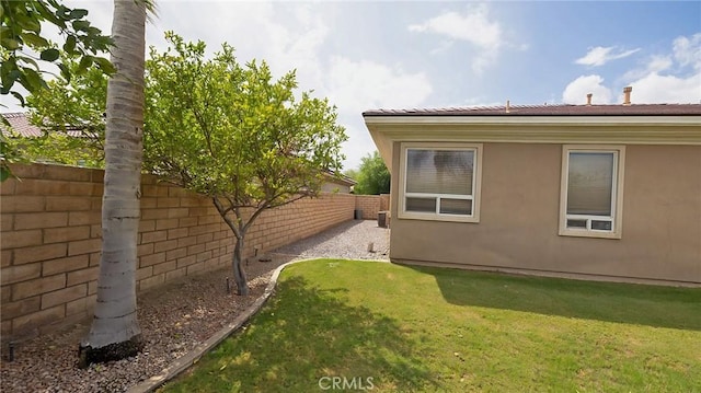 view of side of home featuring a yard